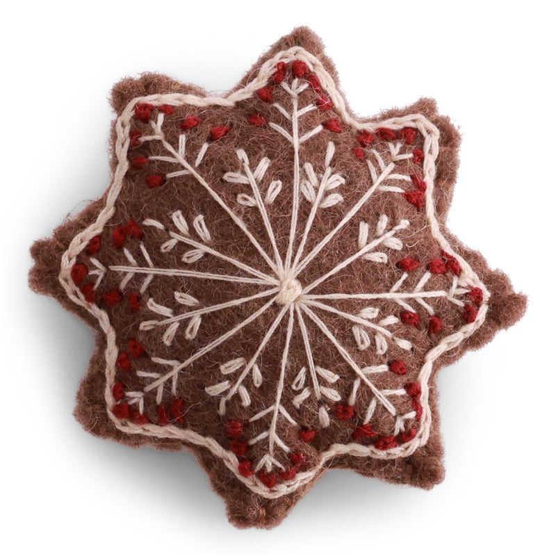 Handmade felted wool gingerbread star ornament with cream and red embroidered snowflake details, designed in Denmark and handmade in Nepal.