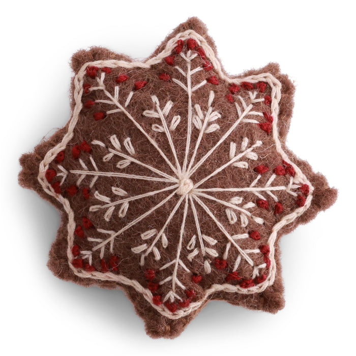 Handmade felted wool gingerbread star ornament with cream and red embroidered snowflake details, designed in Denmark and handmade in Nepal.
