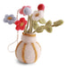 Handmade Gry & Sif felted wool miniature white vase with golden yellow stripes filled with tiny felt flowers and greenery.