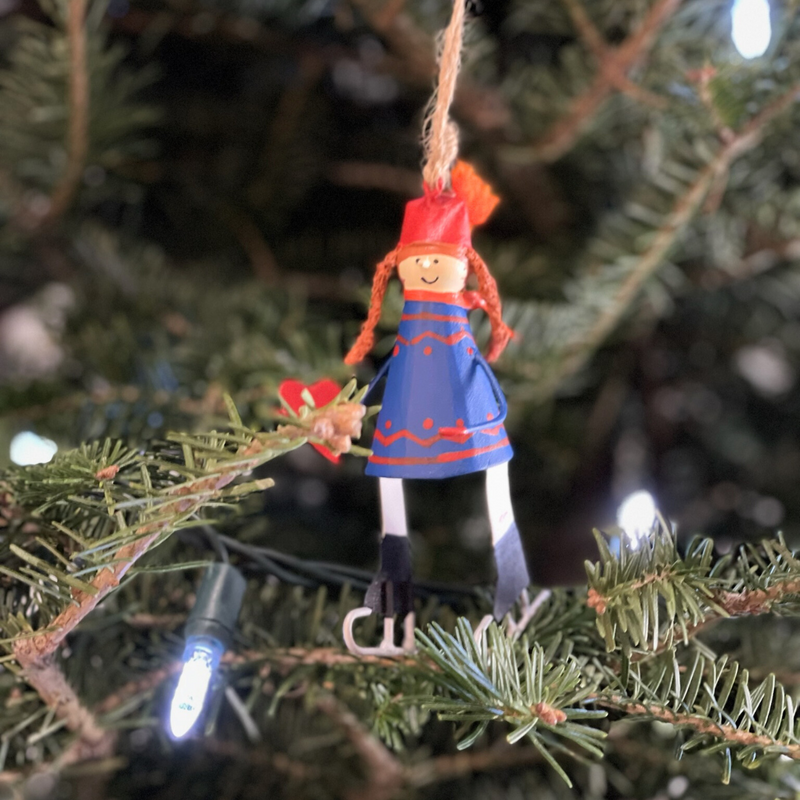 Handmade tin Child on Ice Skates with Heart Christmas ornament wearing a winter scarf, designed in Denmark and handcrafted in the Philippines.