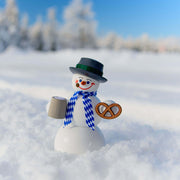 Handcrafted Seiffener Volkskunst Bavarian snowman incense smoker holding a pretzel and bierstein, wearing a blue-and-white scarf and black top hat, made in Seiffen, Germany.