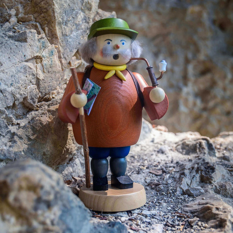 Handcrafted Seiffener Volkskunst Hiker incense smoker with a walking stick, rolled map, backpack and yellow neckerchief, made in Seiffen, Germany.