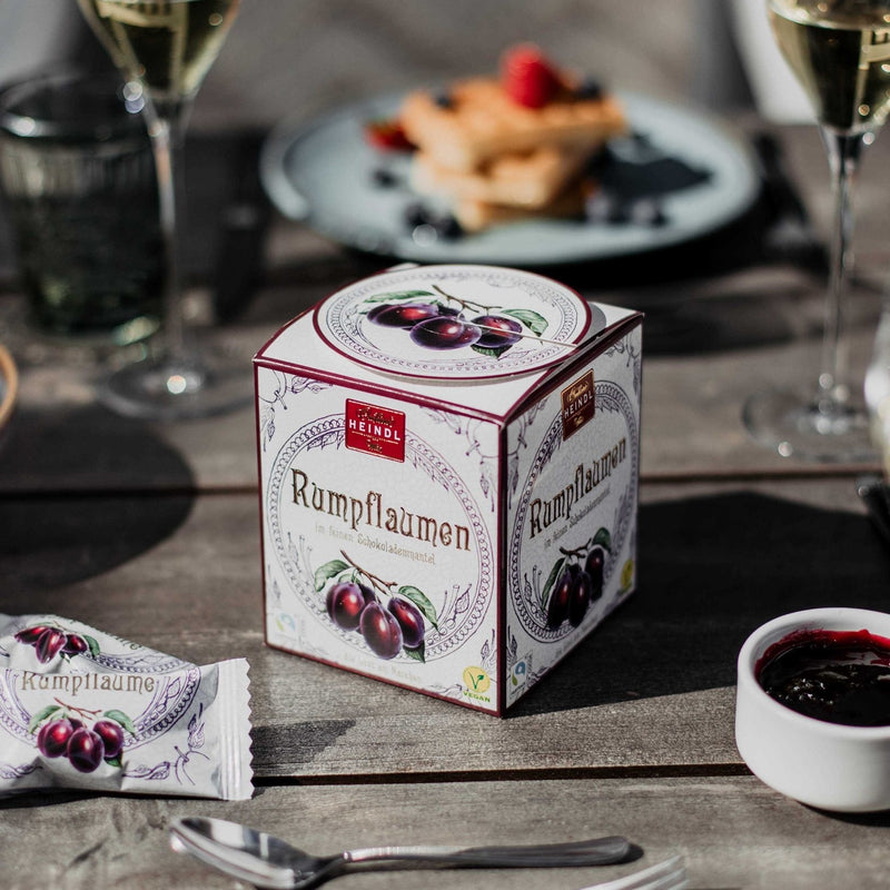 Heindl Rumpflaumen gift cube with individually wrapped dark chocolates filled with whole rum-soaked plums.