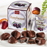 Heindl Rumpflaumen gift cube with individually wrapped dark chocolates filled with whole rum-soaked plums.