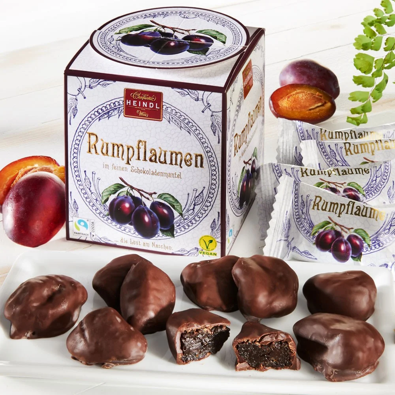 Heindl Rumpflaumen gift cube with individually wrapped dark chocolates filled with whole rum-soaked plums.