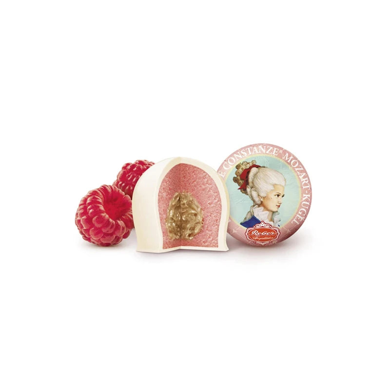 Reber Weiße Constanze® Mozart-Kugeln gift box with six raspberry marzipan pralines coated in white chocolate.
