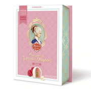 Reber Weiße Constanze® Mozart-Kugeln gift box with six raspberry marzipan pralines coated in white chocolate.