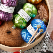 Gingerbread World Inge-Glas Canada - Mouthblown Glass from Germany - Knitting Ornament Ball of Blue Yarn with Needles in basket with other knitting ornaments