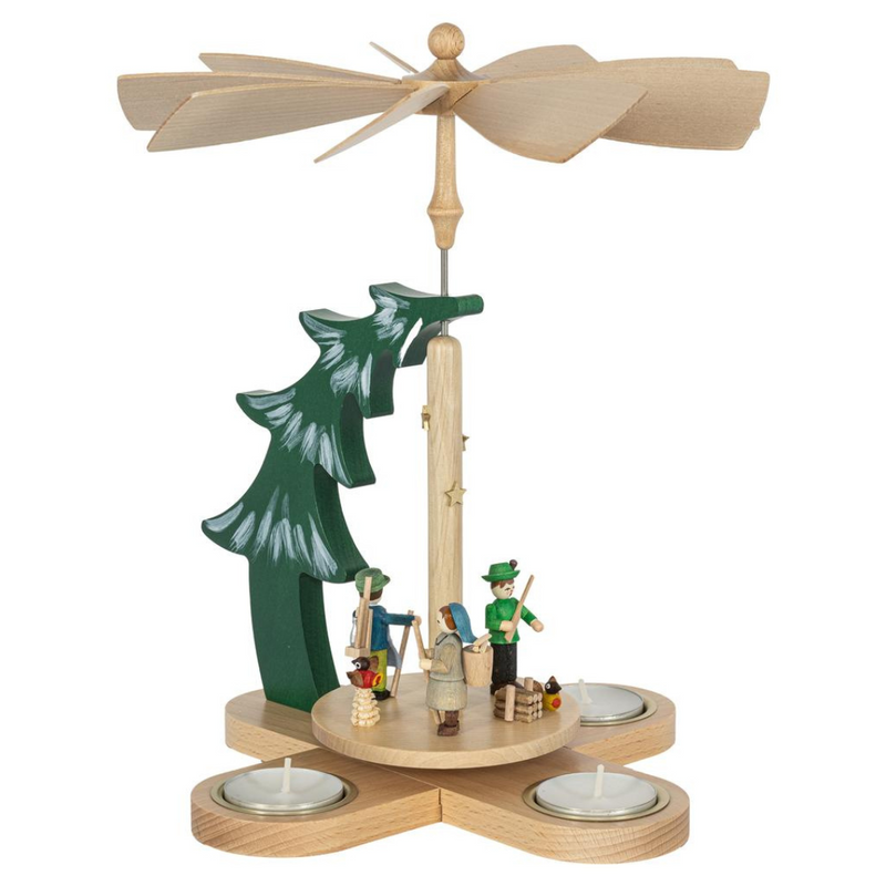 Handcrafted Richard Glässer German Christmas pyramid with a Bavarian woodland scene, featuring a hunter, woodsman and woodland gatherer beneath a snow-covered pine tree.