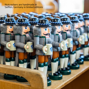 Handcrafted Seiffener Volkskunst Bavarian German nutcracker wearing traditional Tracht and holding a beer stein and heart-shaped Lebkuchen.
