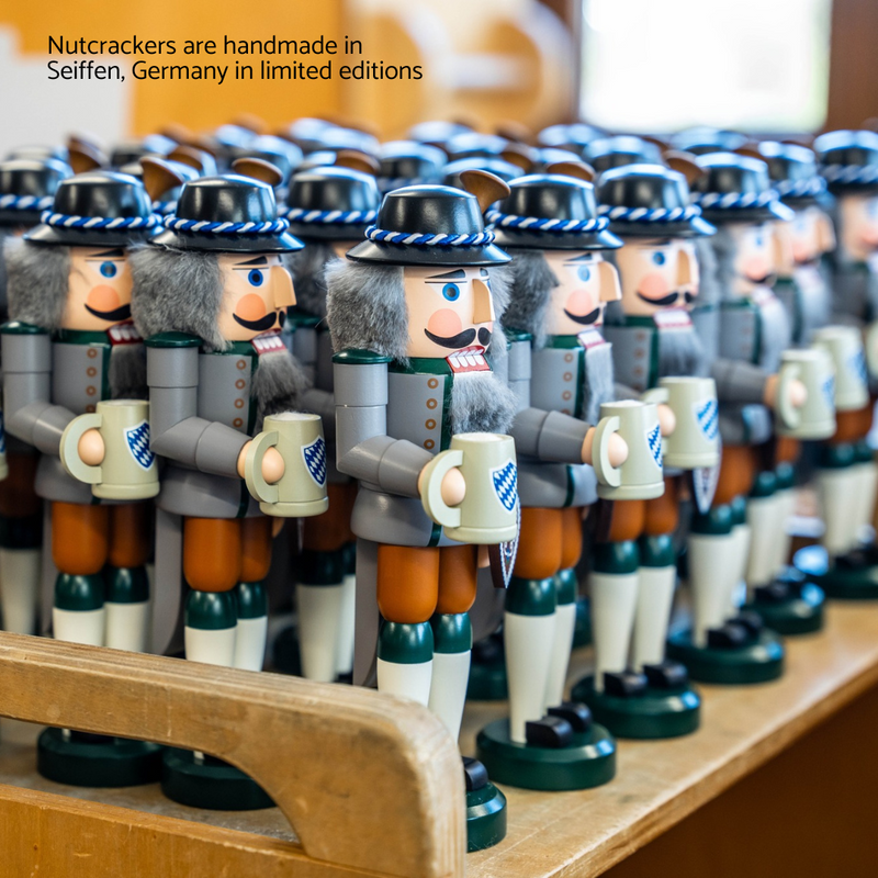 Handcrafted Seiffener Volkskunst Bavarian German nutcracker wearing traditional Tracht and holding a beer stein and heart-shaped Lebkuchen.