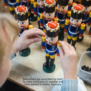 Handcrafted Seiffener Volkskunst Blue King German nutcracker with a golden crown, royal sceptre and faux fur beard, 29 cm.