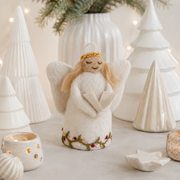 Handmade Gry & Sif felted wool angel ornament with blonde hair, golden halo, white embroidered dress, and miniature songbook.