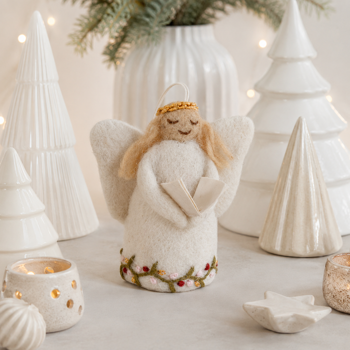 Handmade Gry & Sif felted wool angel ornament with blonde hair, golden halo, white embroidered dress, and miniature songbook.