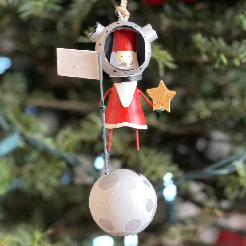 Handmade tin Santa on the Moon Christmas ornament wearing an astronaut suit, designed in Denmark and handcrafted in the Philippines.