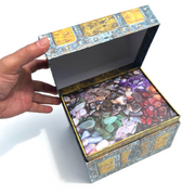 Gemstone Treasure Box Advent Calendar with 24 real polished gemstones hidden behind numbered doors in a pirate-style keepsake chest.