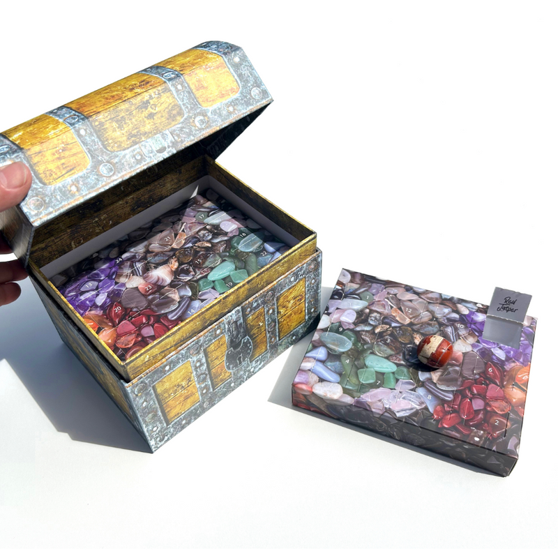 Gemstone Treasure Box Advent Calendar with 24 real polished gemstones hidden behind numbered doors in a pirate-style keepsake chest.