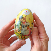 Gingerbread World European Market - Confiserie Heidel Egg-shaped metal gift tin showing front in hands