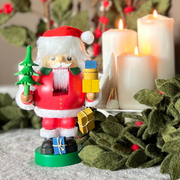 Handcrafted Richard Glässer German Santa Claus nutcracker holding wrapped Christmas gifts, made in Seiffen, Germany.