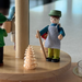 Handcrafted Richard Glässer German Christmas pyramid with a Bavarian woodland scene, featuring a hunter, woodsman and woodland gatherer beneath a snow-covered pine tree 15877