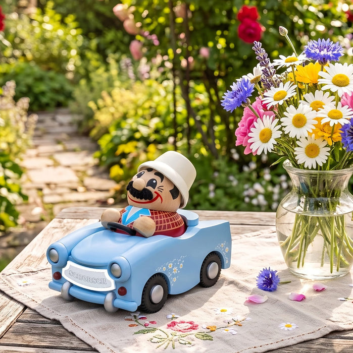 Seiffener Volkskunst limited edition Udo in Trabant German incense smoker displayed on a picnic table outside