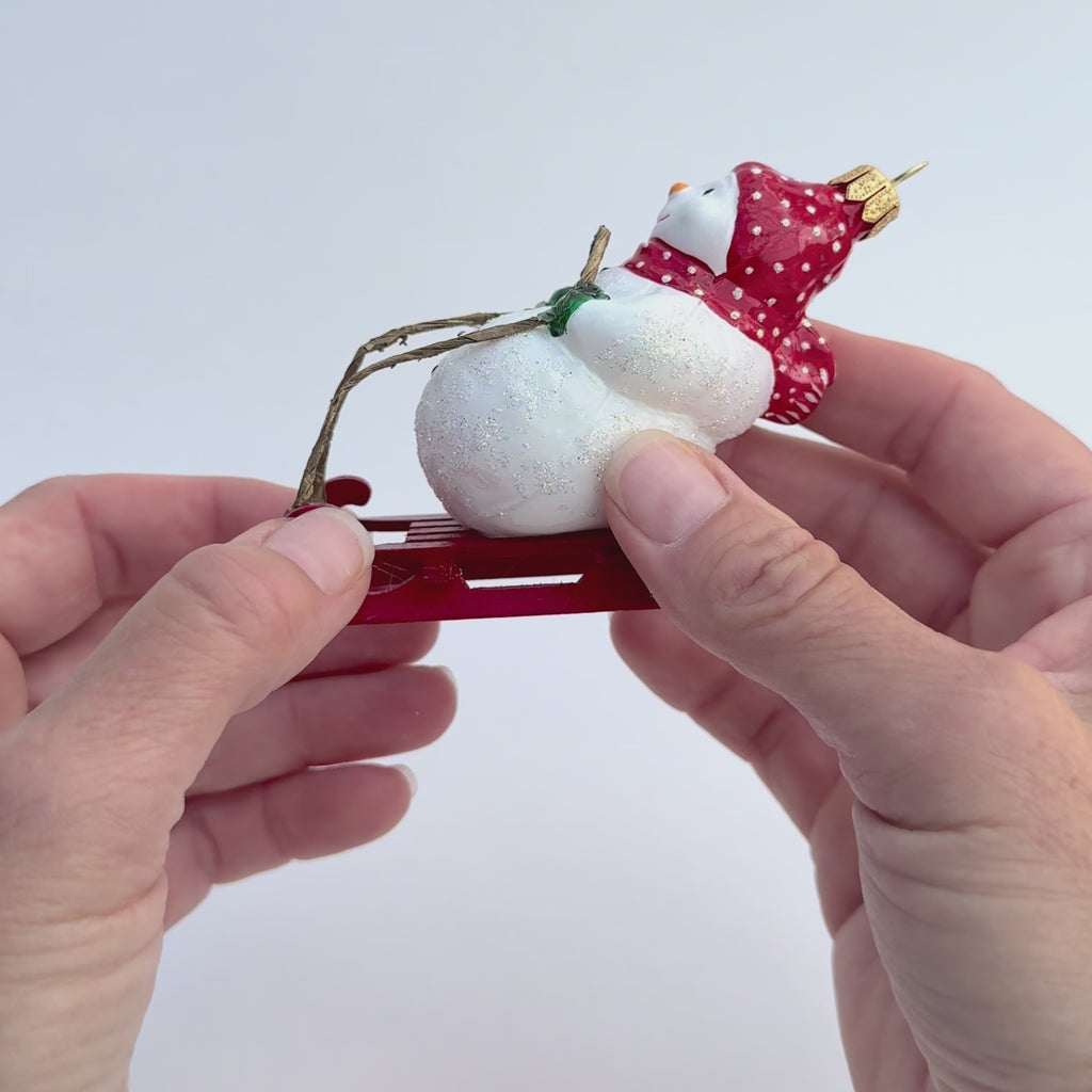 Gingerbread World Polish Blown Glass Ornament – Snowman on Toboggan 162905