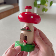 Handcrafted Richard Glässer German toadstool house incense smoker with a red mushroom roof, crooked chimney and ladybug, made in Seiffen, Germany.