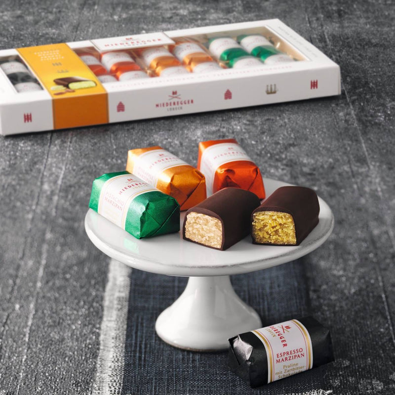 Niederegger Lübeck Marzipan Variations Gift Box with 16 individually wrapped assorted mini marzipan loaves coated in dark chocolate.
