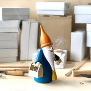 Handcrafted Seiffener Volkskunst Handyman Gnome incense smoker with a brown hat, blue coat, miniature toolbox and broom, made in Seiffen, Germany.