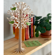 Gingerbread World European Market - Lovi Wooden Creations from the Forests of Finland - 3D wooden Tree with light Green Mini Birds 34 cm shown on bookshelf