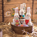 Koza Dereza Ukrainian Easter Bunny Ornaments shown together in wood basket with urkainian motifs in background