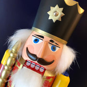 Handcrafted Seiffener Volkskunst Red King German nutcracker with a golden crown, royal sceptre and faux fur beard, made in Seiffen, Germany.