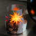 European Ware Haus Herrnhuter Stars Canada - Small Yellow Star displayed in Glass Jar with pine cones