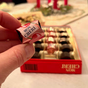 Ferrero Mon Chéri dark chocolate pralines filled with whole cherries and cherry liqueur, 15-piece gift box.